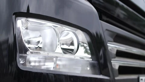 Truck headlights turning on and off, testing different light modes. Video stock 313815447