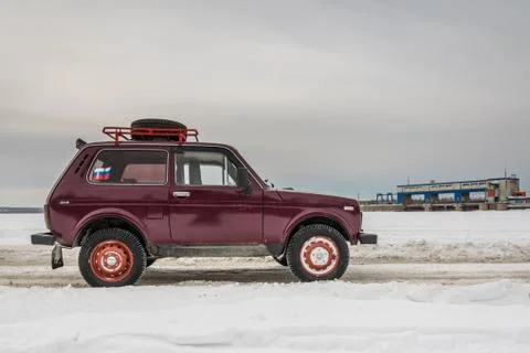 Truck on icy road with snowy landscape Stock Photos
