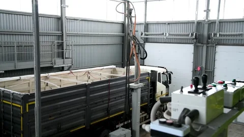 The truck is inside a large warehouse or hangar. A truck with a trailer tha.. Stock Footage 331206895