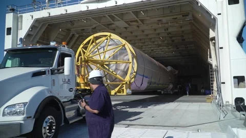 Truck off-loading United Launch Alliance Atlas V rocket booster from cargo ship Stock Footage 274264823