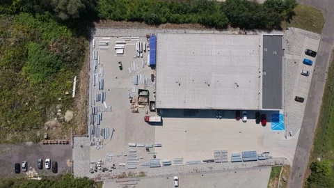 Truck maneuvering at a loading dock of a logistics center from an aerial view Stockbeeldmateriaal 347879632