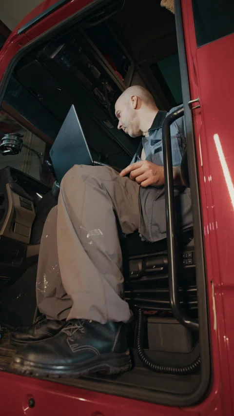 Truck Mechanic Performing Computer Diagnostics inside Cabin Stock Footage 305040705
