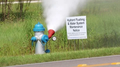 Truck Passes in Front of Flushing Fire Hydrant Stock Footage 52888565