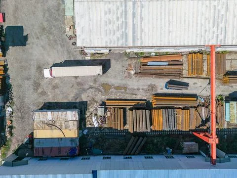 Truck preparing for loading stack of metal pipes with gantry crane Stock Photos