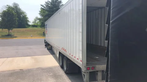 Truck Pulls Away From Warehous Dock After Unloading Its Shippment Stock Footage 243531260