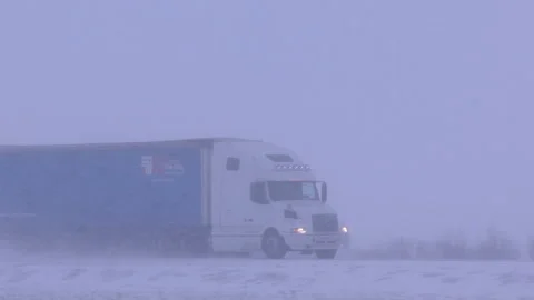 Truck on a snowy winter road. Blizzard. Bad weather. Stock Footage 104802453