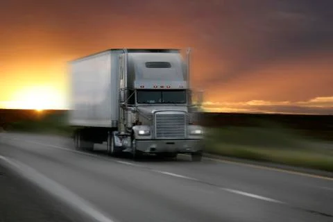 Truck at sunset with motion blur Stock Photos