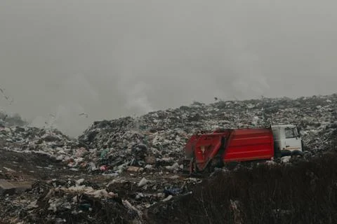 Truck throws garbage in an open garbage dump Stock Photos