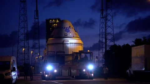 Truck transporting Boeing OFT-2 Starliner spacecraft at night Stock Footage 274264779