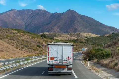Truck transporting solid dangerous goods in bulk driving on the highway Stock Photos