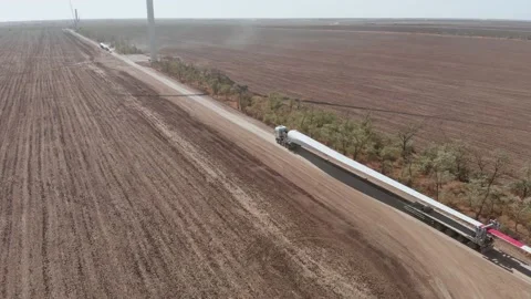 Truck transports blade for wind turbine along rural road Stock Footage