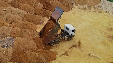 Truck unloading sand and dumping in construction area at telangana, india. day Stock Footage 299885819