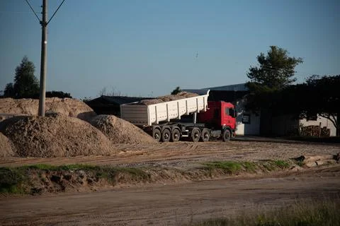 Truck unloading sand cargo for construction-1 Stock Photos