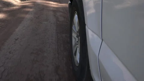 A truck wheel while driving on a rough road through the forest Stock Footage 243376012