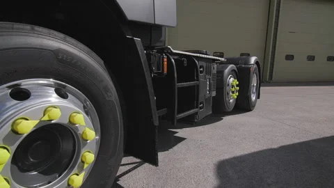 Truck wheels and flat bed hydraulic trailer tracking shot stabilised Stock Footage 161987620