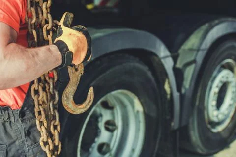 Trucker with Heavy Chains and Hook For Securing Cargo Load.  Stock Photos
