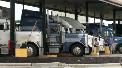 Truckers at a Rest Stop Cleaning their Trucks Stock Footage