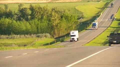 Trucking, extreme long shot trucks in valley highway, #2 Stock Footage