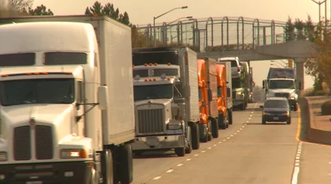 Trucking, Transport trucks on busy freeway Stock Footage