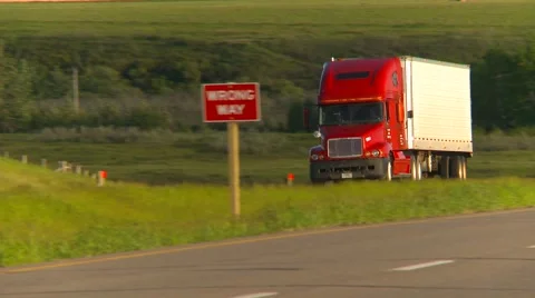 Trucking, truck pan shot, evening, #7 unmarked freight red truck Stock Footage