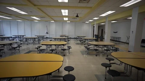 Trucking view to left showing empty school cafeteria with tables and seats. Stock Footage 245103426