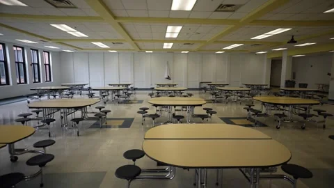 Trucking view to right showing empty school cafeteria with tables and seats. Stock Footage 246007904