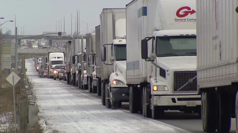 Trucks and tractor trailers stuck on icy highway Stock Footage