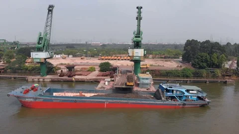 Trucks are loading a ship in the port. Video shooting from the air. Stock Footage 117923060