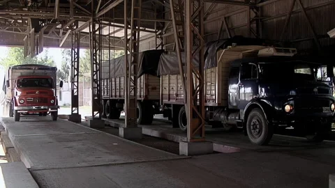 Trucks Arriving at Grain Handling Facility with Loading Platforms - 4K Stock Footage 320557131