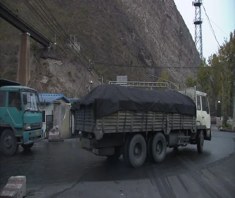 Trucks carrying coal move through town Video stock 86744825