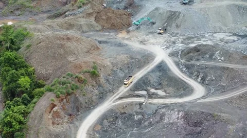 Trucks carrying a load of rocks on uneven roads Stock Footage 313580431