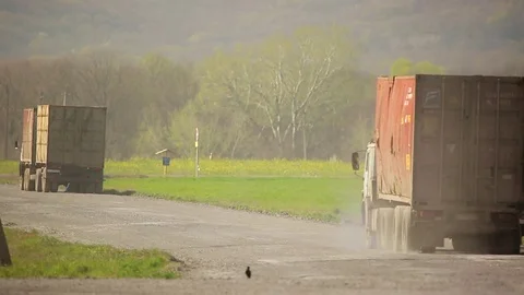 Trucks with containers traveling on the road Stock Footage 72713530