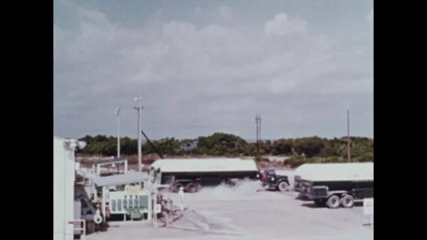 Trucks delivering liquid oxygen to storage facility for Saturn V Third Stage Video stock 297183039