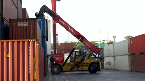Trucks drive past a working reachstacker.  Stock Footage 149468481