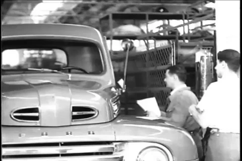 Trucks driven out of the Montevideo ford plant after final inspection - 1948 Stock Footage 94257293