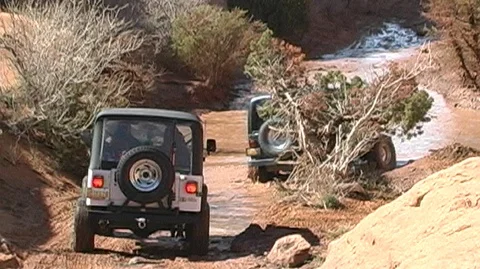 Trucks Driving Through Mud at Off-Road Rally in Southeast Utah Stock Footage 93831902