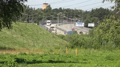 Trucks go over the bridge, the view from afar Vídeo Stock 64717030