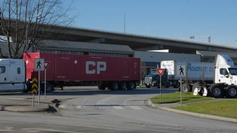 Trucks on intersection in industrial area. Bridge at the background. Stock-Footage 147959289