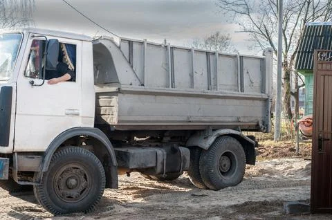 Trucks loaded with construction materials- fine grain sand, Transporting buil Stock Photos