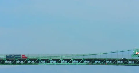 Trucks move cargo containers on the bridge at sea port in Los Angeles 4K RAW Stock Footage 68543405
