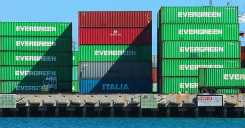 Trucks move cargo containers at the sea port in Los Angeles port 4K RAW Video stock 68546535