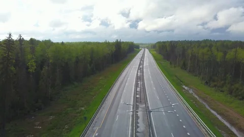 Trucks moving on empty asphalt road among green forest Video stock 119486603