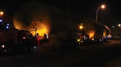 Trucks or lorries with oversized cargoes and flashers at night Stock Footage 49669889