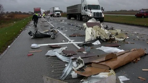 Trucks pass debris on freeway. Stock Footage 93865599