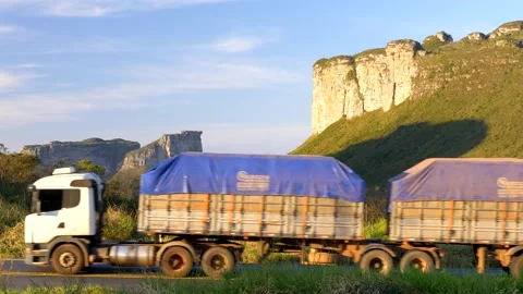 Trucks passing in front of Morro do Pai Inacio and Canyons Stock Footage 154115032