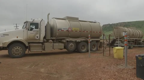 Trucks pump fracking fluid in Bakken oil play Stock Footage 47487232