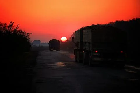Trucks on the road at sunset. selective focus Stock Photos