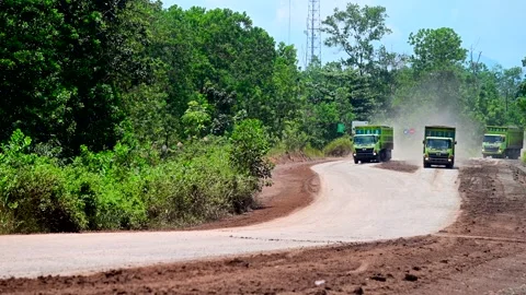 Trucks running side by side on the haul road Stock Footage 245330947