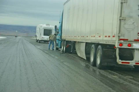 Trucks stop to remove chains Stock Photos