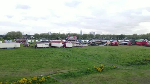 Trucks with trailers and decomposed Luna park attractions standing on meadow Stock-Footage 155848912